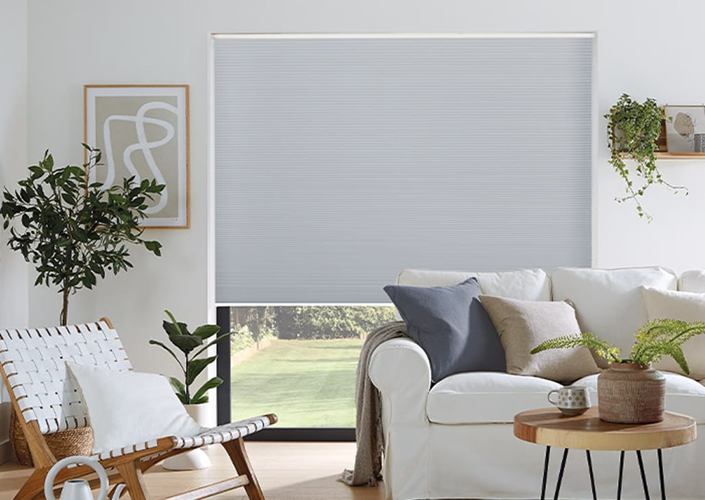 grey blue cellular blinds fitted in a living room.